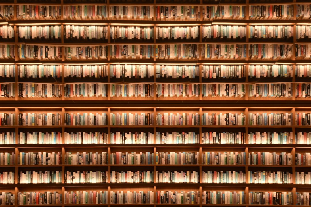 Rows of old books on tall wooden library shelves