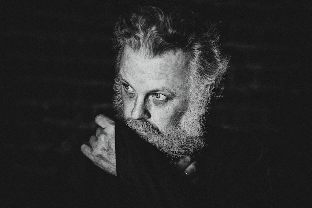 Studio portrait of a middle-aged Croatian man with a beard wearing a dark sweater